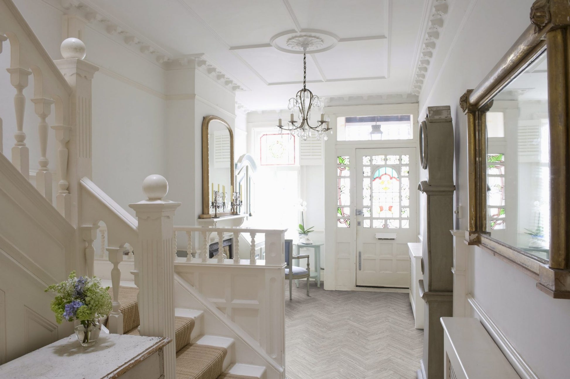 Classic hallway with Luvanto Dryback Herringbone Flooring in neutral wood tone. Waterproof LVT ideal for high-traffic areas.