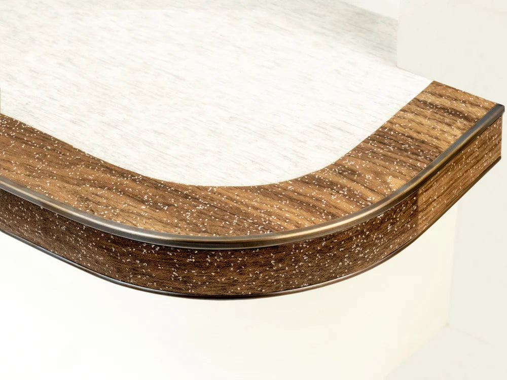Flexible stair nosing in grey finish installed on curved and straight steps, ideal for modern interiors by Premier Trims.