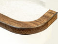 Bendable stair nosing in wood grain finish fitted on a curved step, perfect for custom staircase designs by Premier Trims.