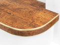 Close-up of bendable stair nosing in rustic wood finish, custom-fit for curved stair edges by Premier Trims.
