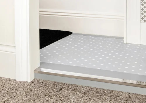 Brushed brass door bar by Premier Trims for carpet and vinyl transitions. Elegant and durable flooring edge solution.
