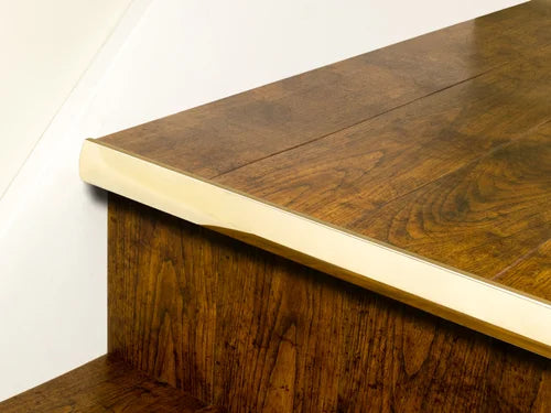 Premier Trims LVT Nosings in gold finish applied to rich brown LVT stair edge, providing stair protection and a luxury accent.