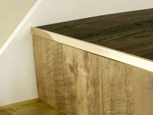 Premier Trims LVT Nosings in brushed brass finish installed on light oak stair edge for LVT stair protection and enhanced durability.