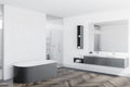 Modern bathroom with Luvanto Dryback Herringbone Flooring in grey wood finish. Waterproof LVT ideal for wet areas.