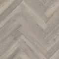 Wooden floor with a herringbone pattern in gray and beige tones.