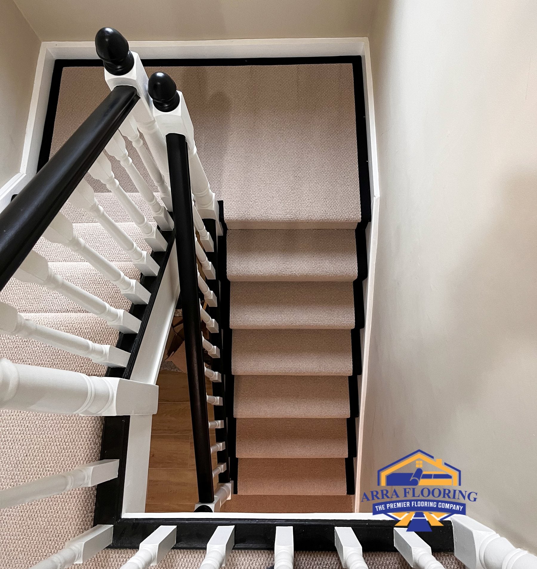Beige stair runner with black edging fitted on a residential staircase